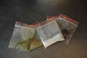 these tiny little bags actually contain some innoculous spices; salt, oregano, red pepper and black pepper